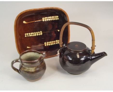 COLDSTONE ETC.
A Coldstone slipware dish, a Lowerdown Pottery small jug & a cane-handled teapot. All marked, teapot with unid