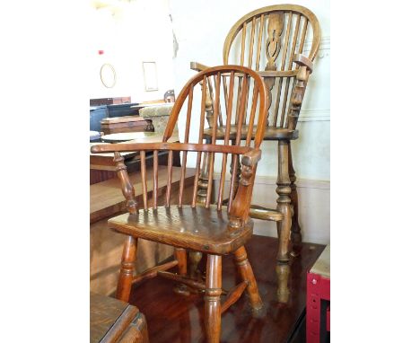 A child's wheel back high chair and an Elm comb back child's chair