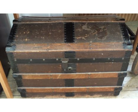 A Victorian domed top metal bound trunk