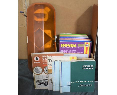A Vehicle Flashing Amber Warning Light and Collection of Workshop Car Manuals 