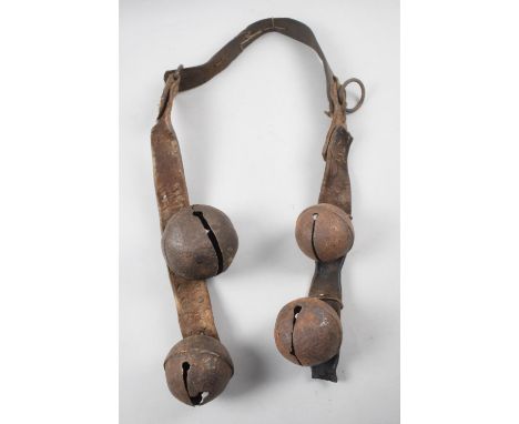A Vintage Leather Strap with Four Globular Cowbells 