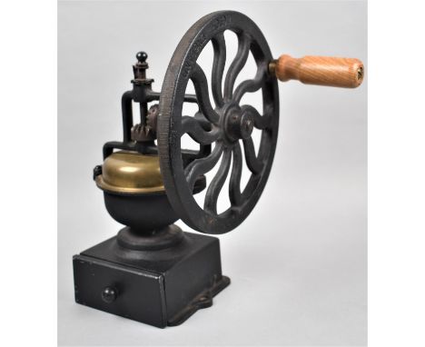 A Cast Iron Brass Mounted Coffee Grinder with Single Drawer and Wooden Handle. 33.5cm high 