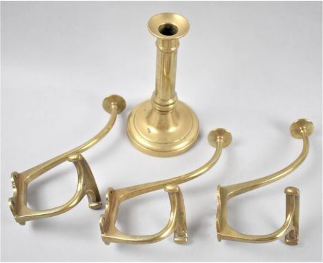 A Set of Three Brass Hat and Coat Hooks, Together with a Late 19th Century Brass Candlestick 