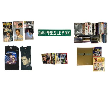 Elvis Presley Memorabilia A collection of books, CDs, VHS tapes and DVDs, T-Shirts and other various items of memorabilia. (2