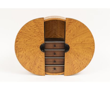The circular case with two sliding doors which open to reveal a shelf and four small drawers, signed and dated on the backboa