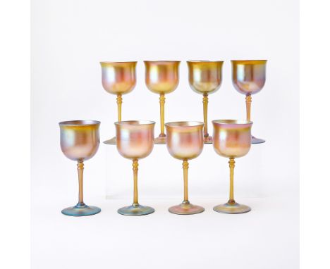 Circa 1905-15Each with a deep circular bowl, applied double-knopped stem, and applied domed circular foot, in transparent amb