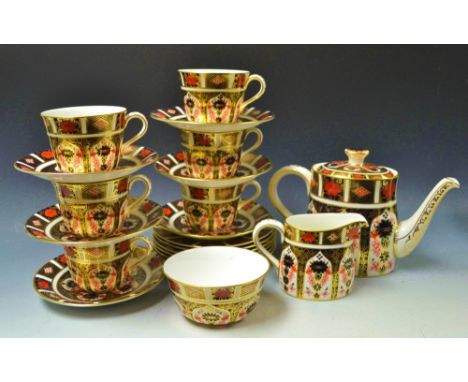 A Royal Crown Derby Imari 1128 pattern tea set comprising teapot, milk and sugar, six teacups, saucers and teaplates, first q