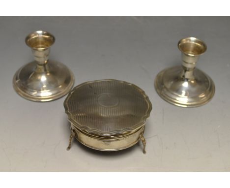 An early 20th century silver jewellery box, engine turned, cabriole supports, Birmingham; a pair of Continental silver boudoi
