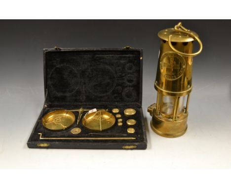 An Eccles miner's lamp, the Projector Lamp and Lighting Co. Ltd., type 6, M&Q; a brass set of scales and weights, boxed (2) 