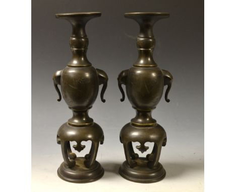 A pair of Chinese bronze vases, of Archaic form, broad rims, stylised elephant handles, shaped scroll aprons, circular bases,