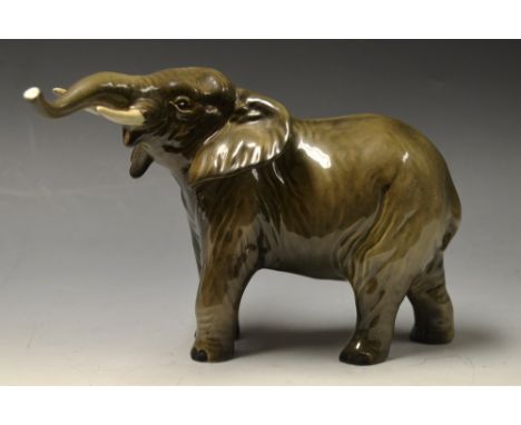 A Beswick model of an Elephant, lifted head and out-stretched trunk, black printed marks, 13cm high 
