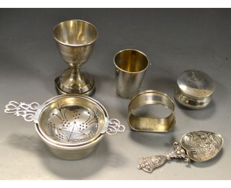 An Elizabeth II silver Balmoral caddy spoon, Edinburgh; an Elizabeth II silver tea strainer and stand, Birmingham 1969; a Geo