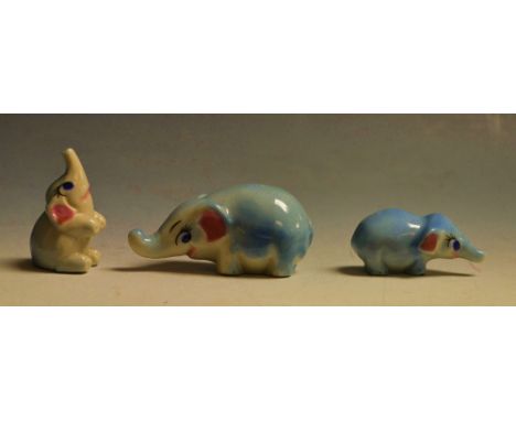 A family of three Wade elephants, each stylised with raised trunk (3)