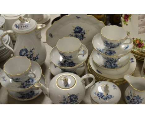 A Meissen tea set printed in underglazed blue with floral sprays and insects, picked out in gilt, comprising teapot, coffee p