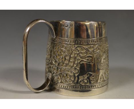 An Anglo-Indian silver christening cup, embossed with a band of stylized temple lions and scrolls blossoming lotus base; Meta