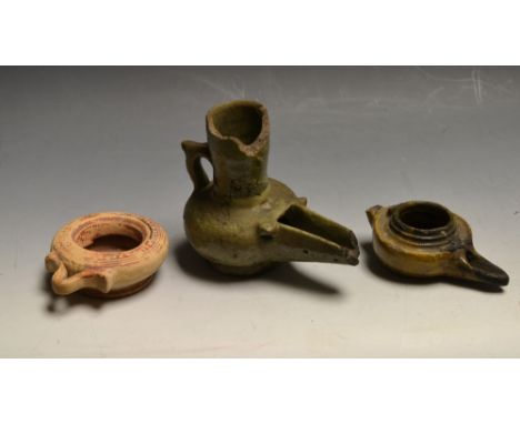 Antiquities - a Roman pottery oil lamp; another vessel; a terracotta scent ring (3)