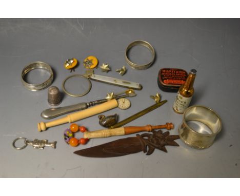 A lace bobbin; two silver napkin rings; a Mighty Atom Cat's Whisker tin; a silver hafted button hook; etc