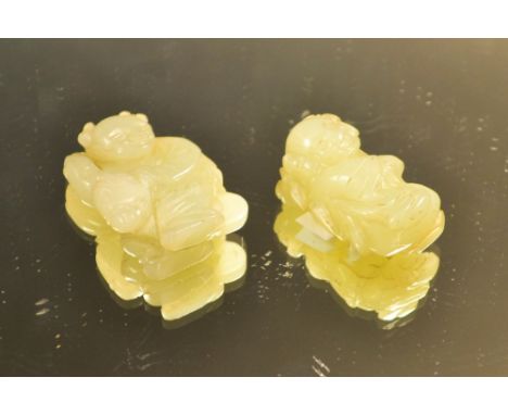 A jade netsuke, carved as an elder riding a horse; another (2)