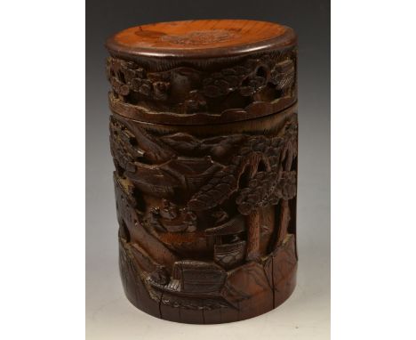 A Chinese bamboo bitong type tea caddy, carved in relief with figures, pagodas and prunus trees on a mountainside, hinged cov