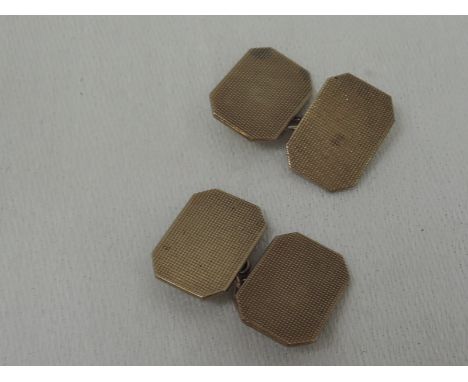 A pair of 9ct gold cufflinks having engine turned chequered decoration and chain connecters, Chester hallmarks, approx 7.1g