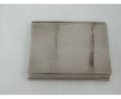 A silver cigarette case having extensive engine turned decoration, slide hinged lid and inscription to inside, Birmingham 193