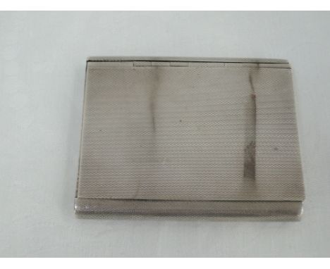 A silver cigarette case having extensive engine turned decoration, slide hinged lid and inscription to inside, Birmingham 193