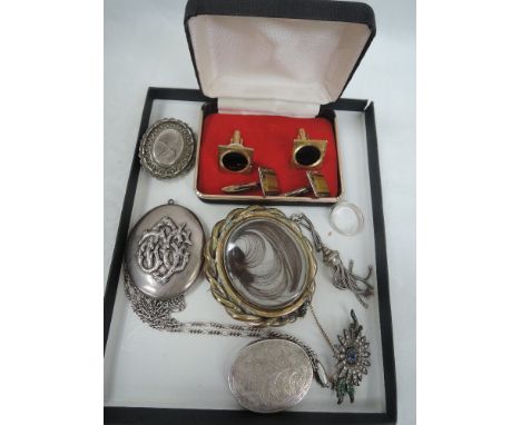 A small selection of white metal jewellery including an engraved oval locket, band ring,diamante brooch, locket pendant and b