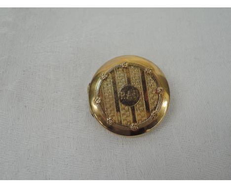 An early 20th century 9ct gold locket brooch of circular form having engine turned and moulded decoration,  approx 11.3g