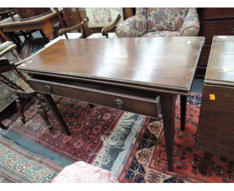 A 19th century mahogany tea table having rectangular fold over top on tapered gate legs