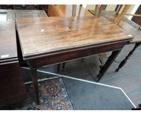 An early 19th century mahogany card table on double tapered gate legs