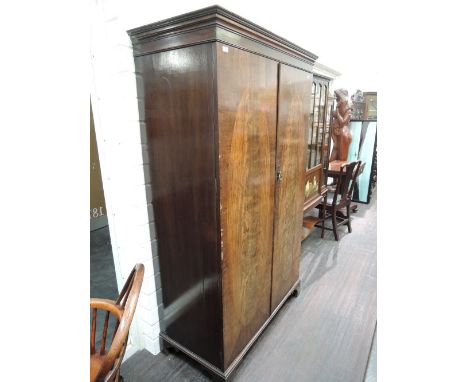 An early/mid 20th century mahogany wardrobe in the Georgian style having bracket feet