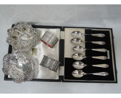 A selection of HM silver including two napkin rings, a cased set of coffee spoons, salt spoon and two small trinket dishes