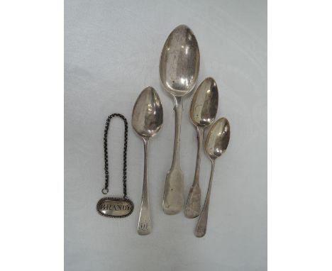 Three Georgian silver teaspoons, a Victorian silver dessert spoon and a Victorian silver Brandy decanter label