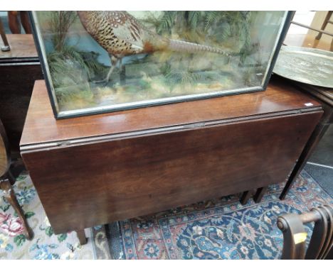 An early 19th century mahogany dining table having rectangular drop leaf top on square gate legs