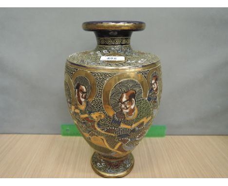 An early 20th century Satsuma vase of gilt heightened pictorial immortal decoration on blue ground