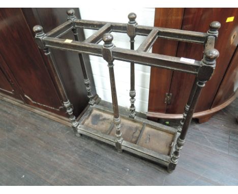 An early 20th century dark oak stick stand having turned frame