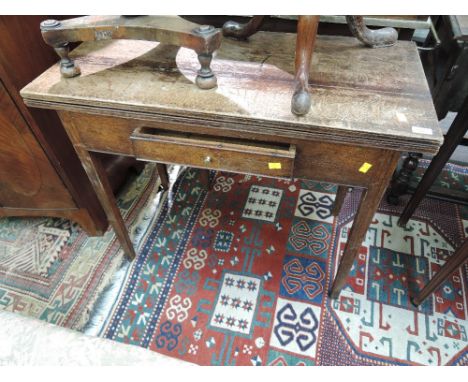 An early 19th century oak tea table having rectangular fold over top with frieze drawer on tapered gate legs