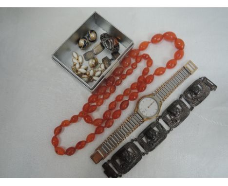 A small selection of costume jewellery including carnelian beads, Baltic amber brooch, Givenchy wrist watch, Christian Dior a