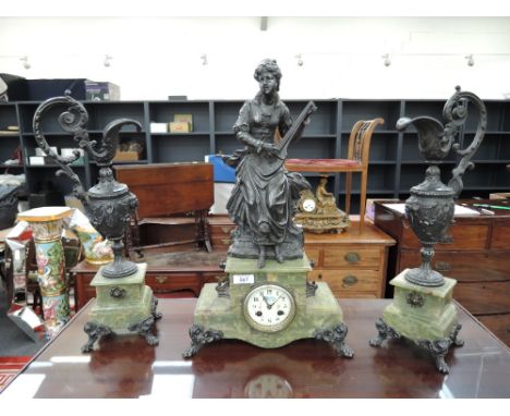 A late 19th century clock garniture having central cast spelter figure modelled as lady playing lute, on onyx stepped base wi