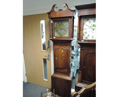 A late 18th century mahogany and oak longcase clock having swan neck pillar hood containing square brass face with 30 hour mo