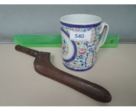 A 19th century treen knitting stick of typical form and a Chinese mug having floral decoration and twist handle