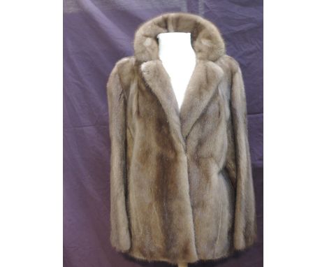 A lady's light brown coloured short mink jacket having silk lining