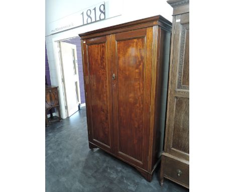 An early 20th century mahogany wardrobe having panel doors
