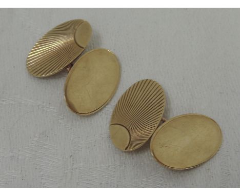 A pair of 9ct gold cufflinks of oval form having engine turned sunrise decoration and chain connectors,  approx 4.9g