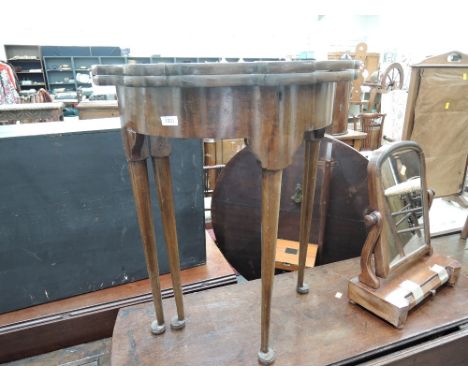 A late 19th/early 20th century mahogany side/tea table in the Georgian style having shaped 'd' top on slender gate legs