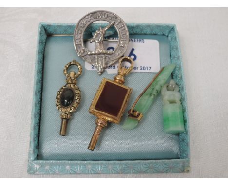 Two pieces of jade including a brooch with yellow metal band and a small carved pendant, a Scottish HM silver brooch bearing 