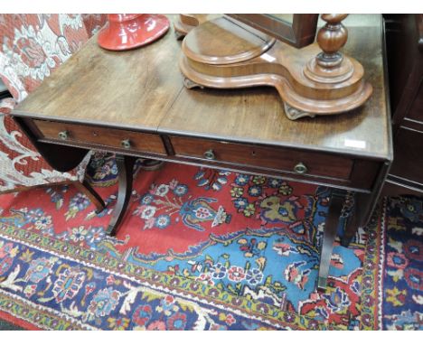 A 19th century mahogany sofa table having drop flaps, false and frieze drawers on splay legs