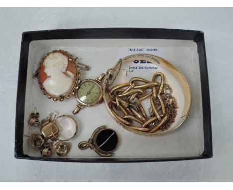 A selection of 9ct gold and yellow metal jewellery including earrings, wrist watch, ring, hinged bangle etc