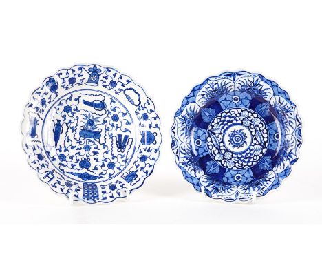 TWO WORCESTER BLUE AND WHITE SMALL LOBED PLATES (2)Circa 1770-80
The first painted with `The Hundred Antiques' pattern, the s