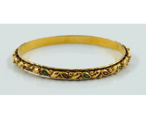 A GOLD ENAMEL BANGLEWith red and green enamel detailing, in unmarked yellow gold, gross weight 15.2 grams, with a case